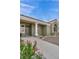 Beautiful home front with a welcoming porch, a decorative wreath on the door, and a well-manicured landscape at 3009 Anna Bay Dr, Las Vegas, NV 89134