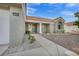 Charming home exterior featuring a well-maintained front yard with a stucco facade, tile roof, and a welcoming entrance at 3009 Anna Bay Dr, Las Vegas, NV 89134