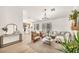 Bright living room featuring modern decor, light wood floors, and seamless access to the kitchen and outdoor patio at 3009 Anna Bay Dr, Las Vegas, NV 89134