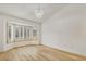 Spacious living room with light-colored hardwood floors and bright bay window at 3009 Anna Bay Dr, Las Vegas, NV 89134