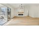 Spacious living room with vaulted ceilings, modern fireplace, shiplap, wood floors, and sliding glass doors at 3009 Anna Bay Dr, Las Vegas, NV 89134