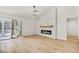 Bright living room with wood floors, vaulted ceilings, fireplace, and sliding glass doors to the enclosed patio at 3009 Anna Bay Dr, Las Vegas, NV 89134