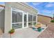 Enclosed patio features views of the yard, rock landscaping, and outdoor seating at 3009 Anna Bay Dr, Las Vegas, NV 89134