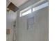 Close-up of a modern shower with rainfall showerhead, mosaic tile inset, and sleek design at 3009 Anna Bay Dr, Las Vegas, NV 89134