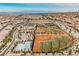 Aerial view of a community with lush landscaping, pool, and multiple baseball fields at 3096 Beaux Art Ave, Henderson, NV 89044