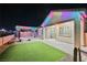 The backyard features a patio, artificial turf, and outdoor lighting, perfect for evening relaxation or entertainment at 3096 Beaux Art Ave, Henderson, NV 89044