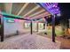 Backyard area offering a covered patio, pavers, artificial turf, and ambient lighting for memorable outdoor gatherings at 3096 Beaux Art Ave, Henderson, NV 89044