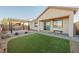 Backyard with artifical turf, xeriscaping, and a covered patio area perfect for entertaining at 3096 Beaux Art Ave, Henderson, NV 89044
