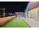 Enjoy a lush backyard with a pergola, patio, and artificial turf that create an inviting outdoor space at 3096 Beaux Art Ave, Henderson, NV 89044