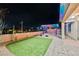 Inviting backyard with a pergola covered in multi-colored festive lighting at 3096 Beaux Art Ave, Henderson, NV 89044