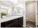Bathroom featuring a granite countertop vanity with a decorative mirror and access to a separate toilet area at 3096 Beaux Art Ave, Henderson, NV 89044