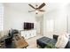 Bedroom with neutral decor and furniture, ceiling fan, work station, and access to an en-suite bathroom at 3096 Beaux Art Ave, Henderson, NV 89044