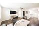 Large bedroom with wood-look floors, ceiling fan, and an ensuite bathroom through the door at 3096 Beaux Art Ave, Henderson, NV 89044