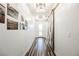 Bright hallway featuring a modern sliding barn door, stylish light fixtures, and tasteful wall art at 3096 Beaux Art Ave, Henderson, NV 89044