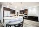 Modern kitchen featuring dark wood cabinets, granite counters and stainless appliances at 3096 Beaux Art Ave, Henderson, NV 89044