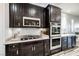 Close-up of the kitchen with stainless steel appliances and white backsplash at 3096 Beaux Art Ave, Henderson, NV 89044