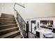Open-concept living space showcasing hardwood stairs to the kitchen and island at 3096 Beaux Art Ave, Henderson, NV 89044