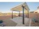Covered patio area, with pavers and xeriscaping, for outdoor living and entertaining at 3096 Beaux Art Ave, Henderson, NV 89044