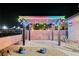 Enjoy the outdoor area with a patio, pergola with festive lighting, and attractive landscaping for a cozy retreat at 3096 Beaux Art Ave, Henderson, NV 89044