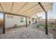The backyard boasts a covered patio, desert landscaping, and a charming walkway for relaxation and entertainment at 3096 Beaux Art Ave, Henderson, NV 89044