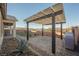 Outdoor patio with brick pavers, a pergola, and desert landscaping to create a welcoming backyard retreat at 3096 Beaux Art Ave, Henderson, NV 89044