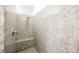 Walk-in shower with stylish granite walls, a built-in bench, and modern fixtures at 3096 Beaux Art Ave, Henderson, NV 89044