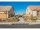 Street view of homes with desert landscaping and community walkway at 3096 Beaux Art Ave, Henderson, NV 89044