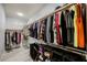Large walk-in closet featuring a variety of clothing and organized shelving at 3096 Beaux Art Ave, Henderson, NV 89044