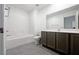 Bathroom featuring a combined shower and tub with tile surround and brown vanity at 3610 Tripoli Cove Ave, Las Vegas, NV 89106