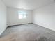 Bedroom with carpet, a large window, and blank walls at 3610 Tripoli Cove Ave, Las Vegas, NV 89106