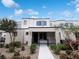Modern townhome featuring a stucco facade, black trim, and desert landscaping at 3610 Tripoli Cove Ave, Las Vegas, NV 89106