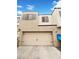 This townhome features a two-car garage with carriage hardware, offering ample parking and storage space at 3610 Tripoli Cove Ave, Las Vegas, NV 89106