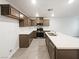 Kitchen with stainless steel appliances, dark cabinets, and a white center island at 3610 Tripoli Cove Ave, Las Vegas, NV 89106