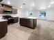 Bright kitchen featuring an island with modern appliances and tile flooring at 3610 Tripoli Cove Ave, Las Vegas, NV 89106