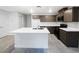 Kitchen featuring white countertops, dark cabinetry, and a kitchen island at 3610 Tripoli Cove Ave, Las Vegas, NV 89106