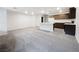 This living room is open to the kitchen and features ample natural light and carpeted floors at 3610 Tripoli Cove Ave, Las Vegas, NV 89106