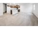 The open-concept layout is visible in this living room leading into a kitchen area with modern countertops at 3610 Tripoli Cove Ave, Las Vegas, NV 89106