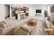This virtually staged living room features stylish furnishings and opens to a kitchen with an island and stainless steel appliances at 3610 Tripoli Cove Ave, Las Vegas, NV 89106
