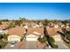 Aerial view of houses with well-manicured lawns and desert landscaping, under a clear blue sky at 364 Rushing Creek Ct, Henderson, NV 89014