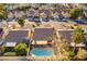 Aerial view showcasing a home with a pool and covered patio in a lush neighborhood at 364 Rushing Creek Ct, Henderson, NV 89014