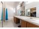 Bathroom featuring a dual sink vanity, large mirror, and shower-tub combination at 364 Rushing Creek Ct, Henderson, NV 89014