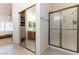 Tiled bathroom featuring a mirrored closet and a glass-door shower at 364 Rushing Creek Ct, Henderson, NV 89014