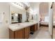 Open bathroom with a double sink vanity, a large mirror, and views to the bedroom at 364 Rushing Creek Ct, Henderson, NV 89014