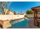 Sparkling pool with decorative tile and concrete surround, enclosed by a privacy wall at 364 Rushing Creek Ct, Henderson, NV 89014