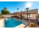 Resort-style backyard with pool, covered patio, desert landscaping and privacy fencing at 364 Rushing Creek Ct, Henderson, NV 89014