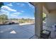 Covered patio with stamped concrete, desert landscaping, and wrought iron fence offering views of the desert at 3841 Budenny Dr, Las Vegas, NV 89122