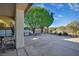 View of backyard featuring a covered patio, built-in grill, desert landscaping, and wrought iron perimeter fence at 3841 Budenny Dr, Las Vegas, NV 89122