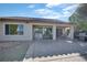 Outdoor patio and desert landscaping with an attached grill, table, and chairs enhancing outdoor living at 3841 Budenny Dr, Las Vegas, NV 89122