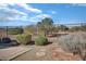 A wrought iron fence surrounds the property, with desert landscaping featuring low bushes and small trees at 3841 Budenny Dr, Las Vegas, NV 89122