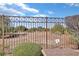 Backyard iron fence offering unobstructed views of the desert landscaping and terrain at 3841 Budenny Dr, Las Vegas, NV 89122